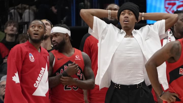 Nov 1, 2024; Toronto, Ontario, CAN; Toronto Raptors guard Immanuel Quickley, guard Jamal Shead (23) and forward Scottie Barnes  and  guard Davion Mitchell (45) and forward Bruce Brown watch a replay on the scoreboard during the second half against the Los Angeles Lakers at Scotiabank Arena. Mandatory Credit: John E. Sokolowski-Imagn Images