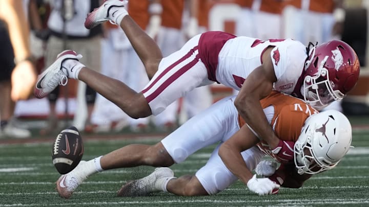 Nov 22, 2025; Austin, Texas, USA; Arkansas Razorbacks defensive back Julian Neal (23) hits Texas Longhorns wide receiver Emmett Mosley V (3) during the first half at Darrell K Royal-Texas Memorial Stadium. Mandatory Credit: Scott Wachter-Imagn Images