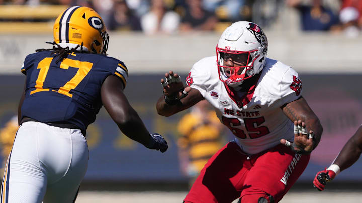 Oct 19, 2024; Berkeley, California, USA; North Carolina State Wolfpack offensive tackle Jacarrius Peak (65) blocks against California Golden Bears linebacker Cheikhsaliou Fall (17) during the second quarter at California Memorial Stadium. Mandatory Credit: Darren Yamashita-Imagn Images