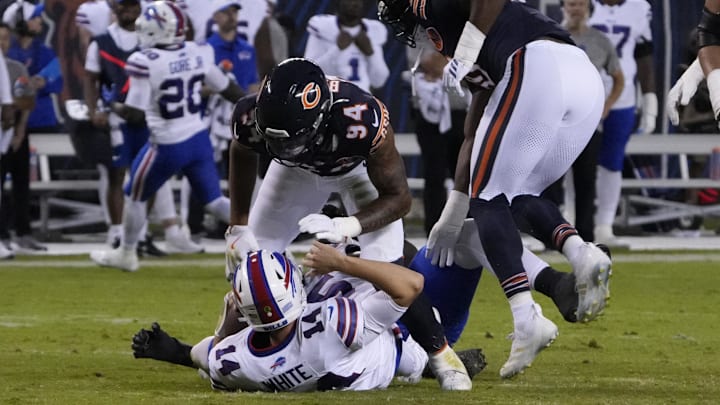 Aug 17, 2025; Chicago, Illinois, USA; Chicago Bears defensive end Austin Booker (94) sacks Buffalo Bills quarterback Mike White (14) during the first half.