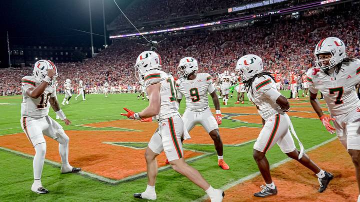 Miami Hurricanes quarterback Darian Mensah (10) congratulates teammate Miami Hurricanes quarterback Vinny Gonzalez (18) after he scored during the first quarter at Memorial Stadium Saturday, October 3, 2026. Miami Hurricanes quarterback Darian Mensah (10) congratulates teammate Miami Hurricanes quarterback Vinny Gonzalez (18) after he scored during the first quarter at Memorial Stadium Saturday, October 3, 2026.