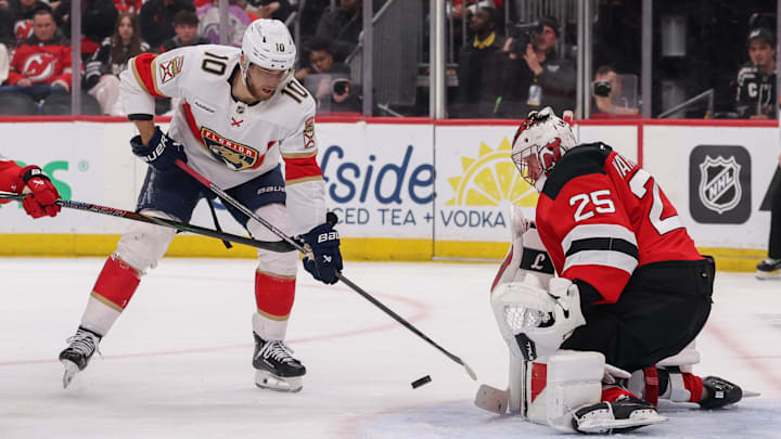 Mar 3, 2026; Newark, New Jersey, USA; New Jersey Devils goaltender Jacob Markstrom (25) makes a save on Florida Panthers left wing A.J. Greer (10) during the first period at Prudential Center. Mandatory Credit: Ed Mulholland-Imagn Images
