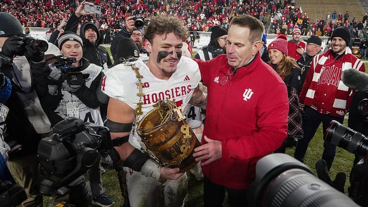 Indiana Hoosiers linebacker Aiden Fisher (4) holds the trophy with Indiana Hoosiers head coach Curt Cignetti Saturday, Nov. 29, 2025, during the 100th annual Old Oaken Bucket game at Ross-Ade Stadium in West Lafayette. Indiana Hoosiers defeated the Purdue Boilermakers, 56-3.