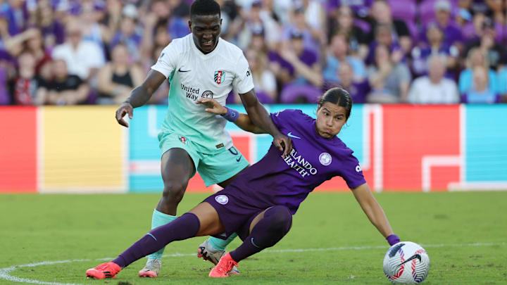 Nov 17, 2024; Orlando, FL, USA; Orlando Pride defender Emily Sams (6) and Kansas City Current forward Nichelle Prince (8) battle for the ball in a NWSL playoff semifinal match at Inter&Co Stadium. Mandatory Credit: Mike Watters-Imagn Images