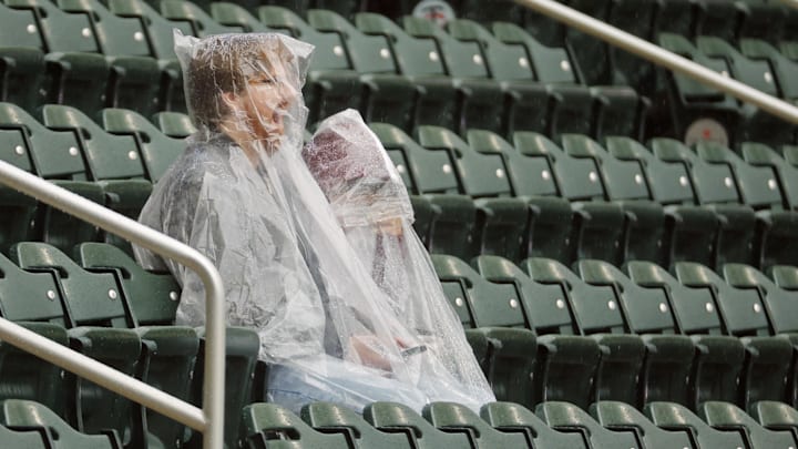 Jun 26, 2025; Minneapolis, Minnesota, USA; Fans sit in the rain as they await the start of the game between the Seattle Mariners and the Minnesota Twins at Target Field.
