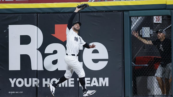 Jul 28, 2025; Chicago, Illinois, USA; Chicago White Sox outfielder Mike Tauchman (18) catches a fly ball hit by Philadelphia Phillies third baseman Otto Kemp (4) during the ninth inning at Rate Field. Mandatory Credit: Kamil Krzaczynski-Imagn Images