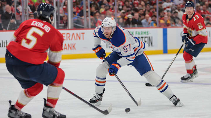 Edmonton Oilers center Connor McDavid (97) moves the puck as Florida Panthers defenseman Aaron Ekblad (5)