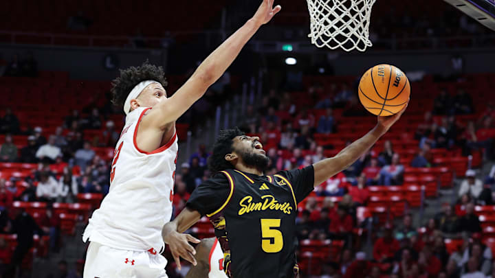 Feb 4, 2026; Salt Lake City, Utah, USA; Arizona State Sun Devils guard Maurice Odum (5) goes to the basket against Utah Utes forward James Okonkwo (32) during the first half at Jon M. Huntsman Center. Mandatory Credit: Rob Gray-Imagn Images