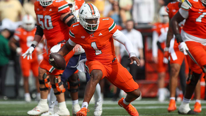 Nov 9, 2024; Atlanta, Georgia, USA; Miami Hurricanes quarterback Cam Ward (1) scrambles against the Georgia Tech Yellow Jackets in the second quarter at Bobby Dodd Stadium at Hyundai Field. Mandatory Credit: Brett Davis-Imagn Images