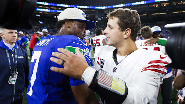 Oct 10, 2024; Seattle, Washington, USA; Seattle Seahawks quarterback Geno Smith (7) shakes hands with San Francisco 49ers quarterback Brock Purdy (13) following a 49er victory at Lumen Field. Mandatory Credit: Joe Nicholson-Imagn Images