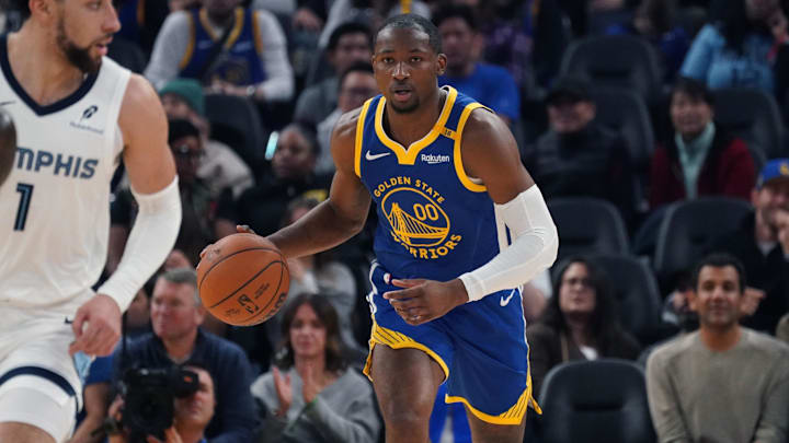 Jan 4, 2025; San Francisco, California, USA;  Golden State Warriors forward Jonathan Kuminga (00) dribbles up court in front of Memphis Grizzlies guard Scotty Pippen Jr. (1) in the second quarter at Chase Center. Mandatory Credit: David Gonzales-Imagn Images
