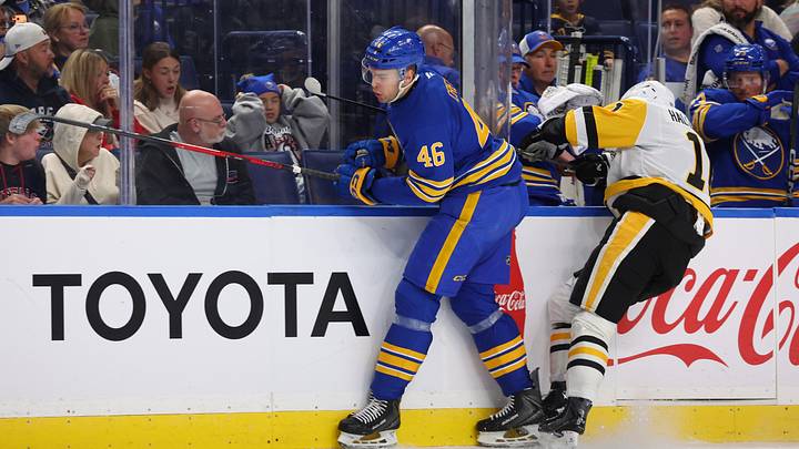 Buffalo Sabres defenseman Louis Crevier (46) checks Pittsburgh Penguins center Filip Hallander (11) during the first period at KeyBank Center. Mandatory Credit: Timothy T. Ludwig-Imagn Images