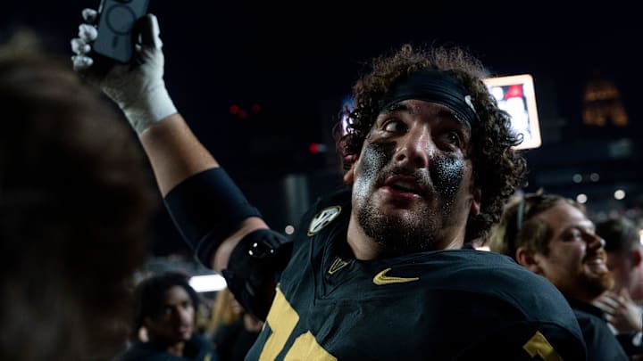 Vanderbilt Commodores offensive lineman Cade McConnell (70) documents the mayhem as fans take down the south end zone goal post after beating No. 1 Alabama 40-35 at Vanderbilt Stadium in Nashville, Tenn., Saturday, Oct. 5, 2024. Vanderbilt Commodores offensive lineman Cade McConnell (70) documents the mayhem as fans take down the south end zone goal post after beating No. 1 Alabama 40-35 at Vanderbilt Stadium in Nashville, Tenn., Saturday, Oct. 5, 2024.