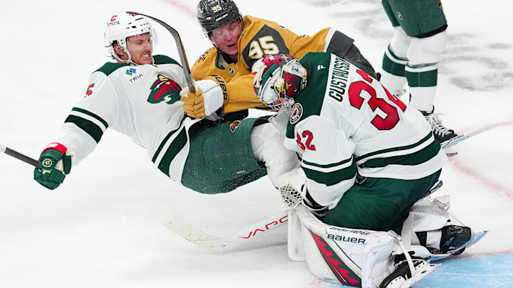 Apr 22, 2025; Las Vegas, Nevada, USA; Minnesota Wild goaltender Filip Gustavsson (32) makes a save as Vegas Golden Knights right wing Victor Olofsson (95) and Minnesota Wild defenseman Jonas Brodin (25) fall to the ice during the third period of game two of the first round of the 2025 Stanley Cup Playoffs at T-Mobile Arena. Mandatory Credit: Stephen R. Sylvanie-Imagn Images