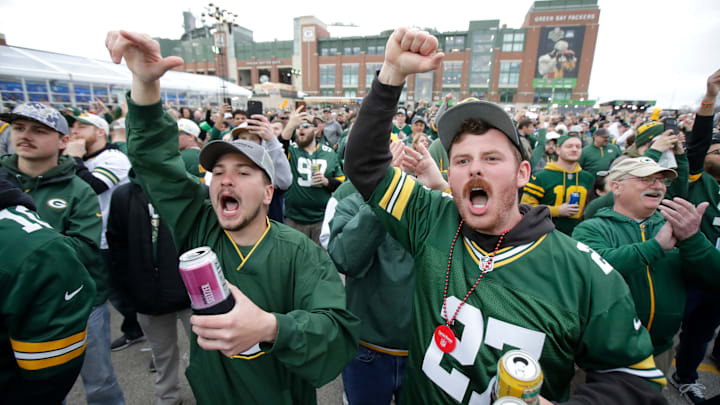 Green Bay Packers fans Hunter Evans, left, of Hartland, WI, and Rodney Wigman of Suxxex, WI, yell “Go Pack Go” during the first day of the NFL Draft presented by Bud Light at the Draft Theater Thursday, April 24, 2025, outside of Lambeau Field in Green Bay, Wisconsin.