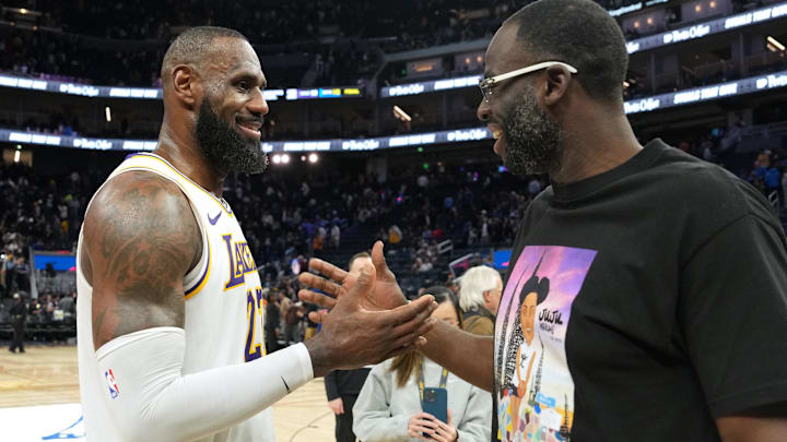 Los Angeles Lakers forward LeBron James (left) talks with Golden State Warriors forward Draymond Green (right) after the game at Chase Center.