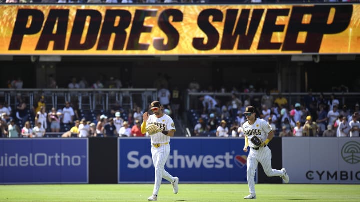 Jun 26, 2024; San Diego, California, USA; San Diego Padres left fielder Tyler Wade (14) and right fielder Bryce Johnson (27) run off the field after defeating the Washington Nationals at Petco Park. Mandatory Credit: Orlando Ramirez-USA TODAY Sports