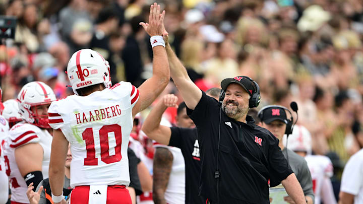 Sep 28, 2024; West Lafayette, Indiana, USA; Nebraska Cornhuskers head coach Matt Rhule high fives quarterback Heinrich Haarberg (10) during the first quarter against the Purdue Boilermakers at Ross-Ade Stadium. Mandatory Credit: Marc Lebryk-Imagn Images