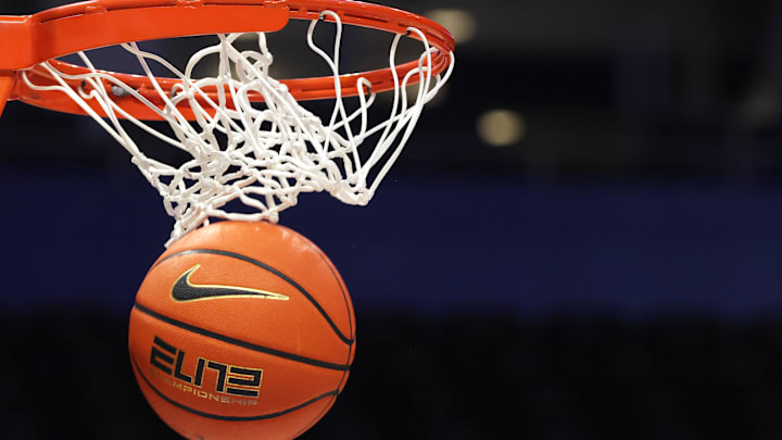 A Nike ELITE branded basketball goes through the hoop.