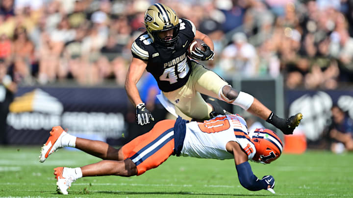 Oct 4, 2025; West Lafayette, Indiana, USA; Purdue Boilermakers running back Devin Mockobee (45) jumps over Illinois Fighting Illini defensive back Miles Scott (10) during the first quarter at Ross-Ade Stadium. Mandatory Credit: Marc Lebryk-Imagn Images Oct 4, 2025; West Lafayette, Indiana, USA; Purdue Boilermakers running back Devin Mockobee (45) jumps over Illinois Fighting Illini defensive back Miles Scott (10) during the first quarter at Ross-Ade Stadium. Mandatory Credit: Marc Lebryk-Imagn Images