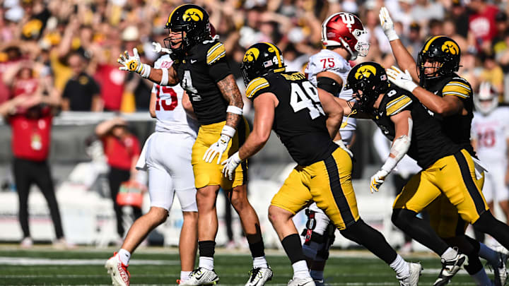 Sep 27, 2025; Iowa City, Iowa, USA; Iowa Hawkeyes defensive back Koen Entringer (4) and defensive lineman Ethan Hurkett (49) and teammates react after a 4th down stop against the Indiana Hoosiers during the second quarter at Kinnick Stadium. Mandatory Credit: Jeffrey Becker-Imagn Images