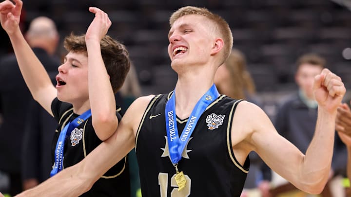 Mt. Vernon Marauders guard Owen Daugherty (14) and guard Luke Ertel (12) celebrate a state title.