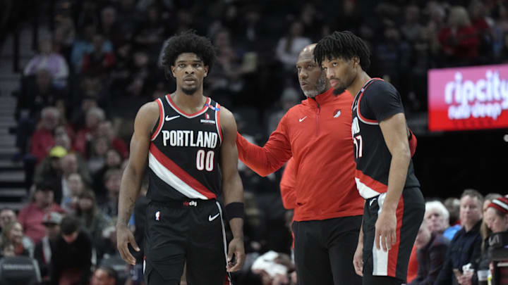 Jan 14, 2025; Portland, Oregon, USA; Portland Trail Blazers head coach Chauncey Billups talks to Scoot Henderson (00) and Shaedon Sharpe (17) during the first half against the Brooklyn Nets at Moda Center. Mandatory Credit: Soobum Im-Imagn Images