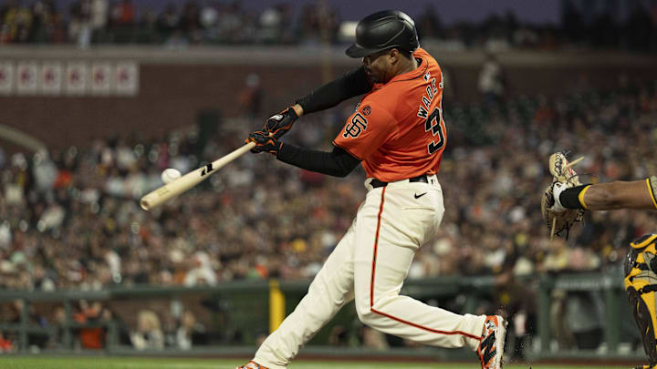 Sep 13, 2024; San Francisco, California, USA; San Francisco Giants first base LaMonte Wade Jr. (31) hits a single during the first inning against the San Diego Padres at Oracle Park. Sep 13, 2024; San Francisco, California, USA; San Francisco Giants first base LaMonte Wade Jr. (31) hits a single during the first inning against the San Diego Padres at Oracle Park.