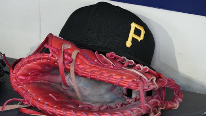 Jun 23, 2025; Milwaukee, Wisconsin, USA; against the Pittsburgh Pirates hat and glove in the dugout before a game against the Milwaukee Brewers at American Family Field. Mandatory Credit: Michael McLoone-Imagn Images