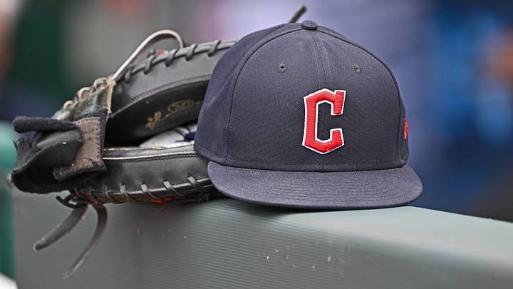 Jun 27, 2024; Kansas City, Missouri, USA; A general view a Cleveland Guardians hat and glove on the dugout railing  before a game against the Kansas City Royals at Kauffman Stadium. Mandatory Credit: Peter Aiken-Imagn Images