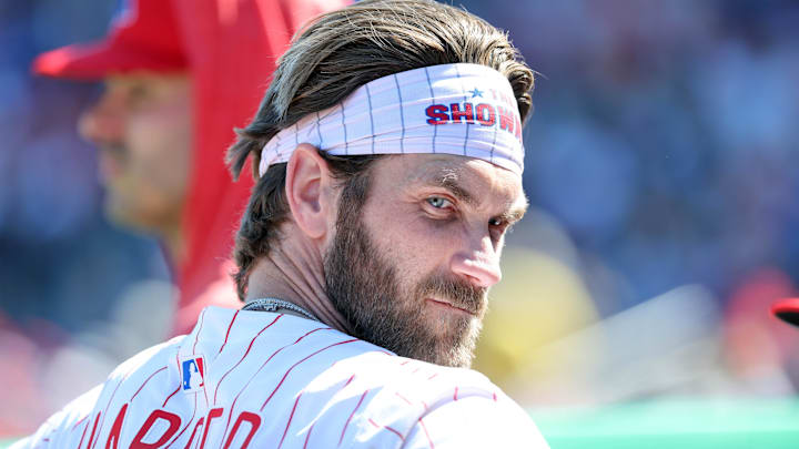 Feb 28, 2025; Clearwater, Florida, USA;  Philadelphia Phillies first base Bryce Harper (3) looks on in the dugout against the Boston Red Sox at BayCare Ballpark. Mandatory Credit: Kim Klement Neitzel-Imagn Images