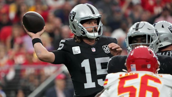 Oct 27, 2024; Paradise, Nevada, USA; Las Vegas Raiders quarterback Gardner Minshew (15) throws the ball against Kansas City Chiefs defensive end George Karlaftis (56) in the first half at Allegiant Stadium. Mandatory Credit: Kirby Lee-Imagn Images