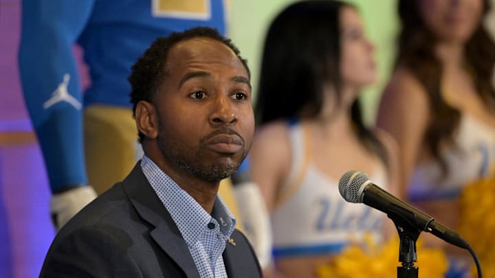 Feb 13, 2024; Los Angeles, CA, USA;  UCLA Bruins athletic director Martin Jarmond listens as DeShaun Foster speaks to media after he was introduced as the new head football coach during a press conference at Pauley Pavilion.  Mandatory Credit: Jayne Kamin-Oncea-Imagn Images