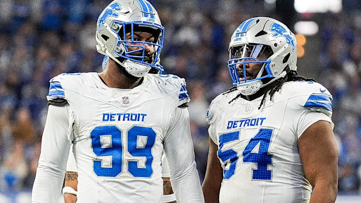 Detroit Lions defensive end Za'Darius Smith (99), left, talks to defensive tackle Alim McNeill (54) at a timeout against Indianapolis Colts during the second half at Lucas Oil Stadium in Indianapolis, Ind. on Sunday, Nov. 24, 2024.