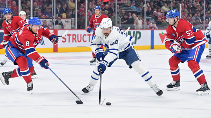 Mar 10, 2026; Montreal, Quebec, CAN; Toronto Maple Leafs forward Auston Matthews (34) plays the puck against Montreal Canadiens defensemen Mike Matheson (8) and Noah Dobson (53) during the third period at the Bell Centre. Mandatory Credit: Eric Bolte-Imagn Images