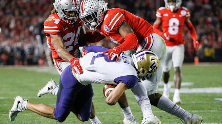 Ohio State corner Shaun Wade (24) and safety Jordan Fuller bring down Huskies wide receiver Aaron Fuller in the 2019 Rose Bowl.