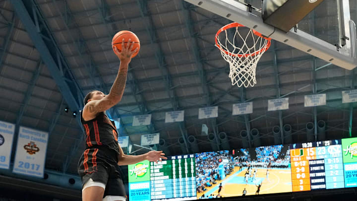 Mar 1, 2025; Chapel Hill, North Carolina, USA; Miami (Fl) Hurricanes guard Matthew Cleveland (0) shoots as North Carolina Tar Heels forward Jae'Lyn Withers (24) defends in the first half at Dean E. Smith Center. Mandatory Credit: Bob Donnan-Imagn Images Mar 1, 2025; Chapel Hill, North Carolina, USA; Miami (Fl) Hurricanes guard Matthew Cleveland (0) shoots as North Carolina Tar Heels forward Jae'Lyn Withers (24) defends in the first half at Dean E. Smith Center. Mandatory Credit: Bob Donnan-Imagn Images
