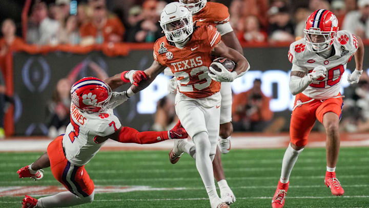 Texas Longhorns running back Jaydon Blue (23) stiff arms Clemson Tigers safety Khalil Barnes (7) as he runs toward the end zone in the second half of an NCAA College Football Playoffs first round game at Darrell K Royal Texas Memorial Stadium, Austin, Texas, Saturday, Dec. 21, 2024.