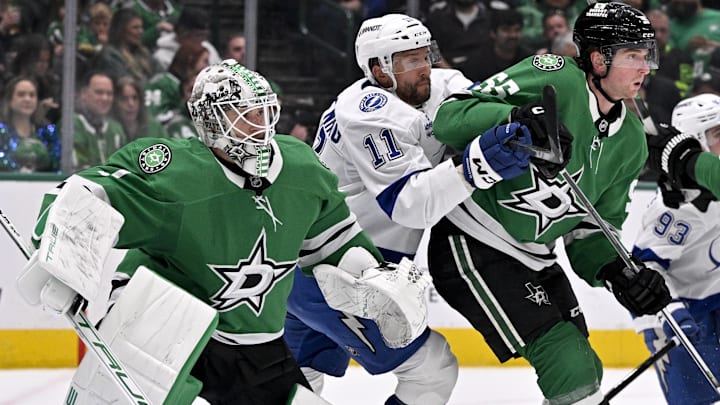 Mar 20, 2025; Dallas, Texas, USA; Tampa Bay Lightning center Luke Glendening (11) battle for position between Dallas Stars goaltender Casey DeSmith (1) and defenseman Thomas Harley (55) during the first period at the American Airlines Center. Mandatory Credit: Jerome Miron-Imagn Images