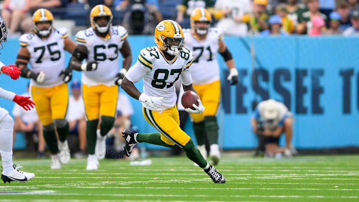 Sep 22, 2024; Nashville, Tennessee, USA;  Green Bay Packers wide receiver Romeo Doubs (87) makes a catch and runs the ball against the Tennessee Titans during the first half at Nissan Stadium. Mandatory Credit: Steve Roberts-Imagn Images