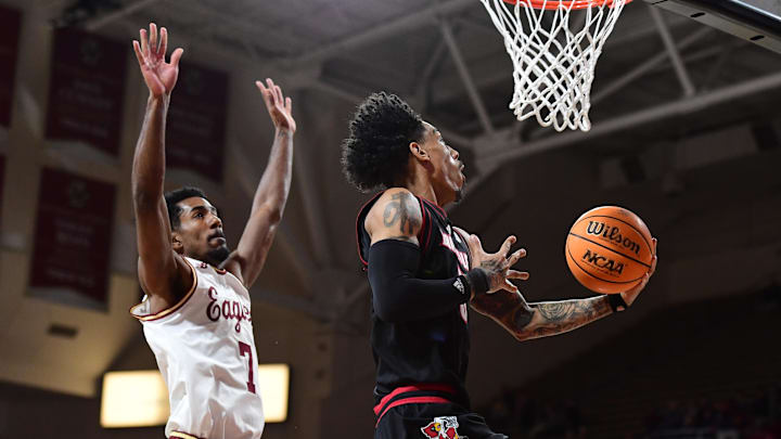 Feb 5, 2025; Chestnut Hill, Massachusetts, USA; Louisville Cardinals guard Terrence Edwards Jr. (5) drives to the basket past Boston College Eagles guard Joshua Beadle (7) during the first half at Conte Forum.