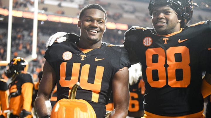 Tennessee linebacker Elijah Herring (44) holds a Tennessee-themed pumpkin after the NCAA football