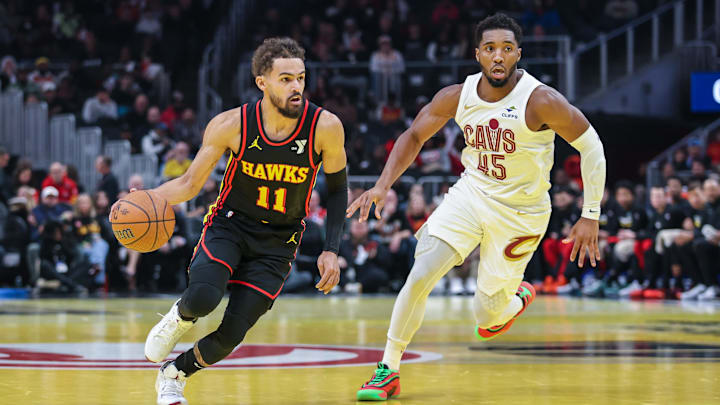 Nov 29, 2024; Atlanta, Georgia, USA; Atlanta Hawks guard Trae Young (11) dribbles the ball past Cleveland Cavaliers guard Donovan Mitchell (45) during the first quarter at State Farm Arena. Mandatory Credit: Jordan Godfree-Imagn Images