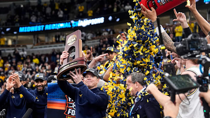 Michigan coach Dusty May celebrates after the Wolverines beat Illinois in the Midwest Regional final to advance to the Final Four. Michigan coach Dusty May celebrates after the Wolverines beat Illinois in the Midwest Regional final to advance to the Final Four.