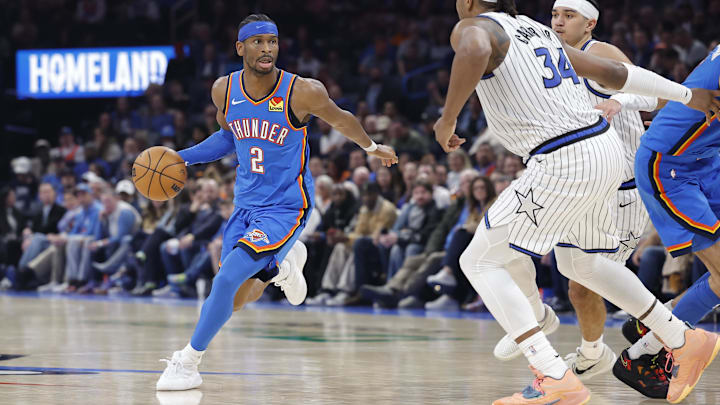 Feb 3, 2026; Oklahoma City, Oklahoma, USA; Oklahoma City Thunder guard Shai Gilgeous-Alexander (2) drives around Orlando Magic center/forward Wendell Carter Jr. (34) during the second half at Paycom Center.