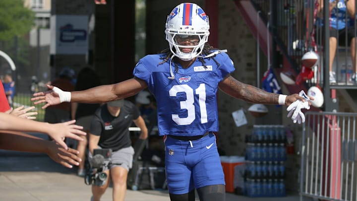 Bills rookie CB Maxwell Hairston high-fives fans as he runs onto the field during day five of Buffalo Bills training camp.