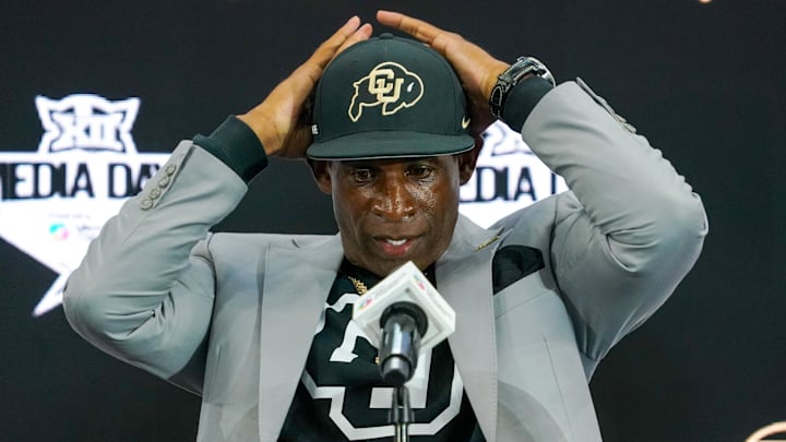 Jul 9, 2025; Frisco, TX, USA; Colorado head coach Deion Sanders fixes his cap prior to speaking with the media during 2025 Big 12 Football Media Days at The Star. Mandatory Credit: Raymond Carlin III-Imagn Images Jul 9, 2025; Frisco, TX, USA; Colorado head coach Deion Sanders fixes his cap prior to speaking with the media during 2025 Big 12 Football Media Days at The Star. Mandatory Credit: Raymond Carlin III-Imagn Images