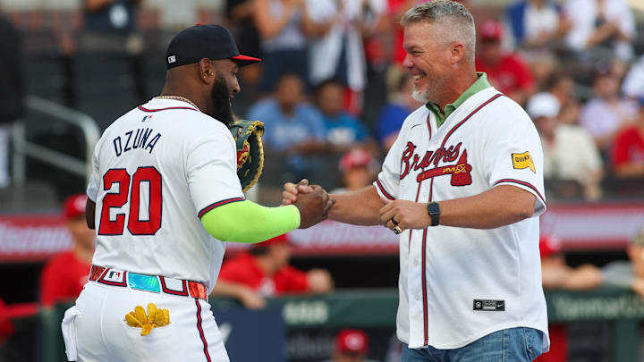 Jul 22, 2024; Atlanta, Georgia, USA; Former Atlanta Braves third baseman Chipper Jones (10) talks to designated hitter Marcell Ozuna (20) after throwing out the first pitch against the Cincinnati Reds at Truist Park. Mandatory Credit: Brett Davis-Imagn Images
