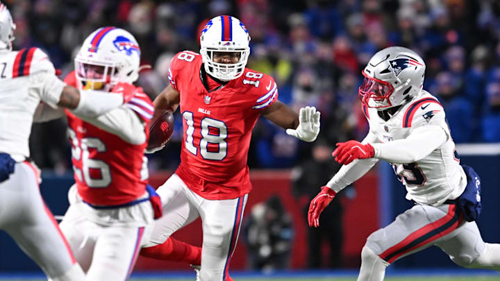 Dec 22, 2024; Orchard Park, New York, USA; Buffalo Bills wide receiver Amari Cooper (18) stiff arms New England Patriots linebacker Christian Elliss (53) in the second quarter at Highmark Stadium.