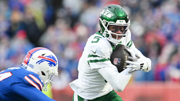 Dec 29, 2024; Orchard Park, New York, USA; New York Jets wide receiver Garrett Wilson (5) tries to get past Buffalo Bills safety Cole Bishop (24) after making a catch in the second quarter at Highmark Stadium. Dec 29, 2024; Orchard Park, New York, USA; New York Jets wide receiver Garrett Wilson (5) tries to get past Buffalo Bills safety Cole Bishop (24) after making a catch in the second quarter at Highmark Stadium.